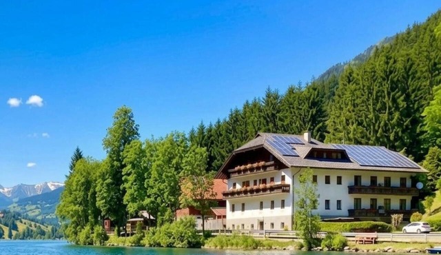 Apartment with private beach at an Alpine lake
